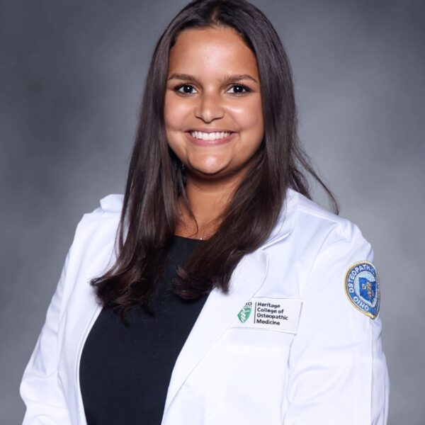 Headshot of Rosa Negash, a CONTINUUM scholar, in a white labcoat